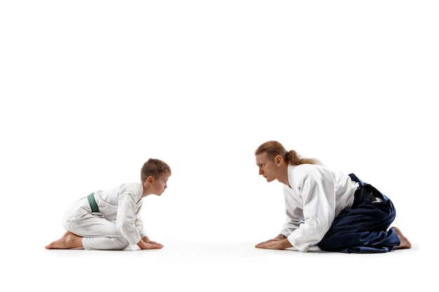 Man and teen boy at aikido training in martial arts school