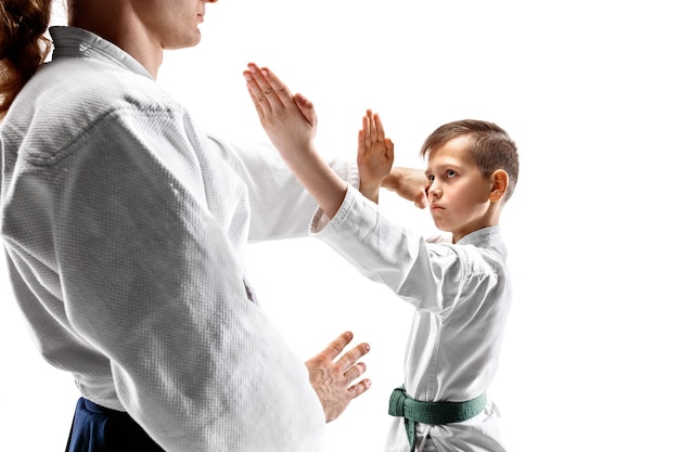 Man and teen boy fighting at Aikido training in martial arts school. Healthy lifestyle and sports concept.