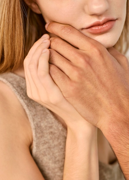 Man touching woman's chin with his hand