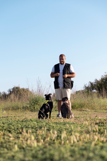 Man training his two dogs outdoors