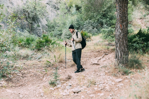 Free photo man trekking in mountains