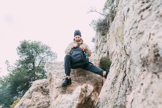 Free photo man trekking in mountains