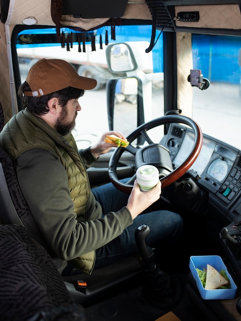 Free photo man in truck with food high angle