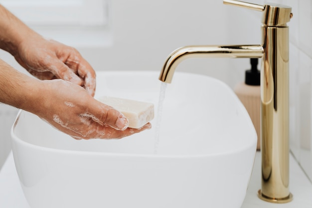 Man using a bar soap to wash his hands