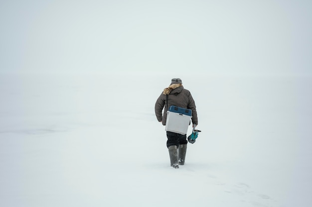 Man using a box for the fish he caught