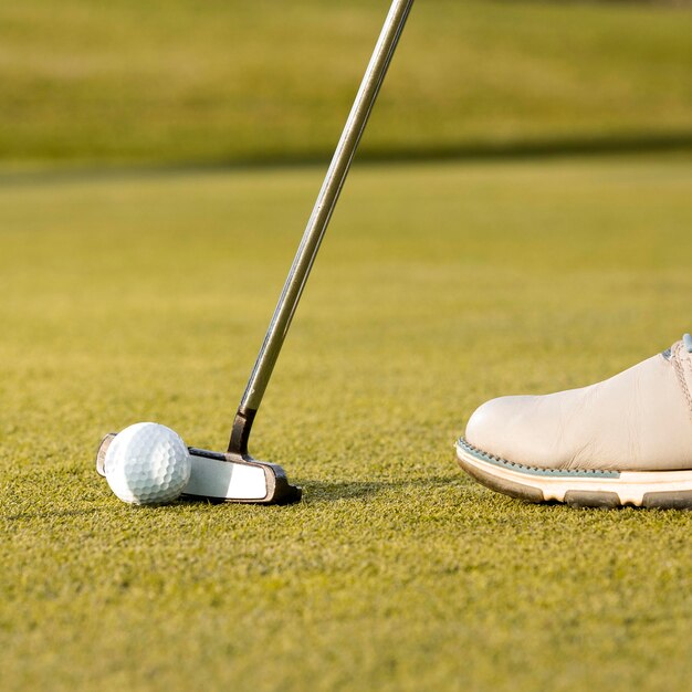 Man using club to hit the golf ball