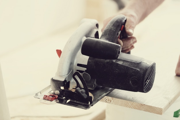 Man using electric saw at carpentry shop