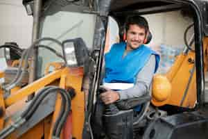 Free photo man using an excavator for digging on day light