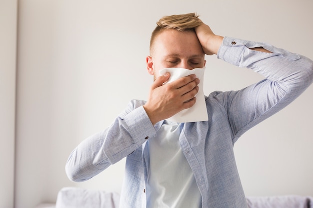 Free Photo man using handkerchief