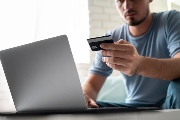 Man using his credit card to play online for an order