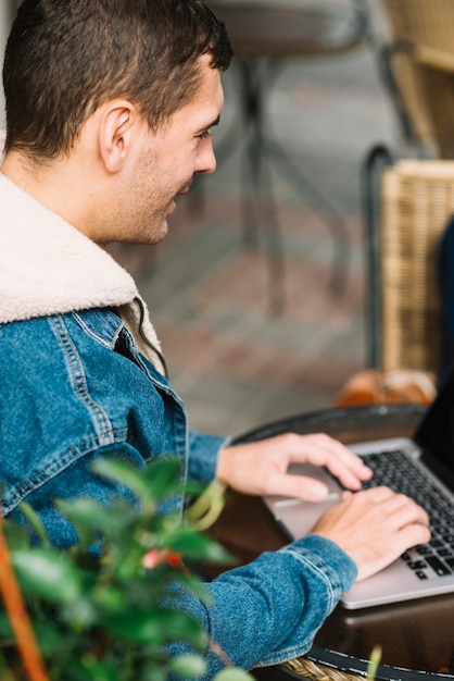 Man using laptop in urban environment