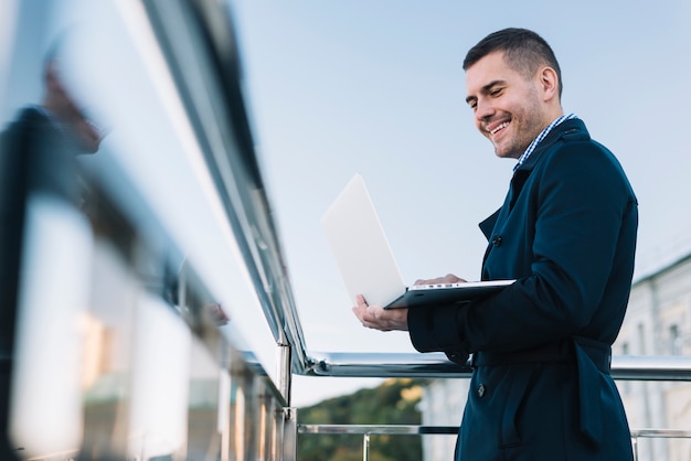 Man using laptop in urban environment