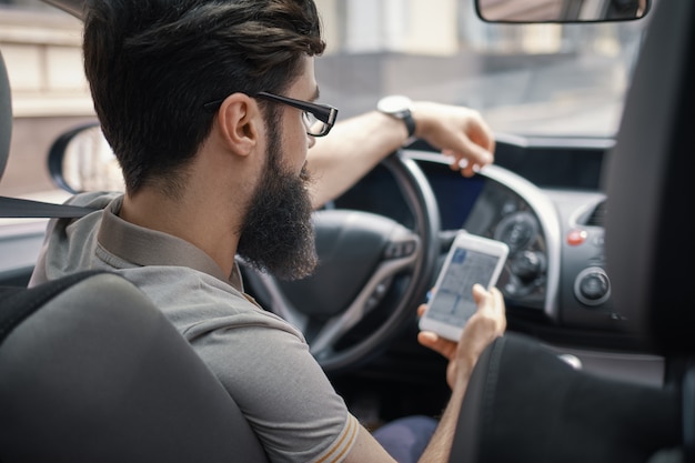 Man using mobile phone while driving.