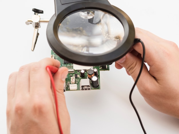 Free Photo man using multimeter to check board