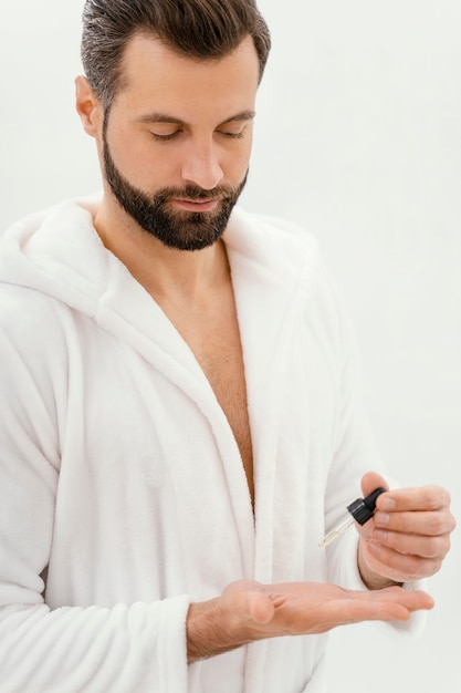 Man using natural oils for his face