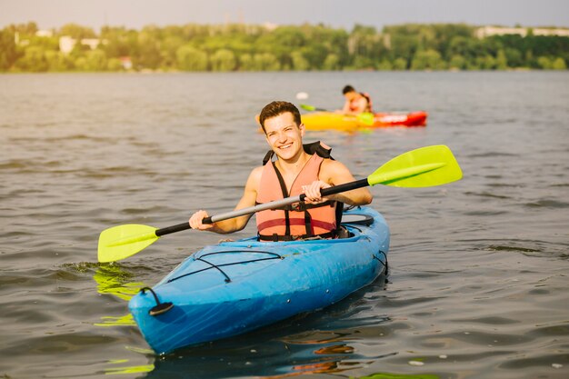 Free Photo man using paddle while kayaking in water