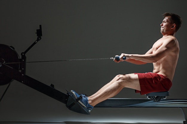 Man Using A Press Machine In A Fitness Club.