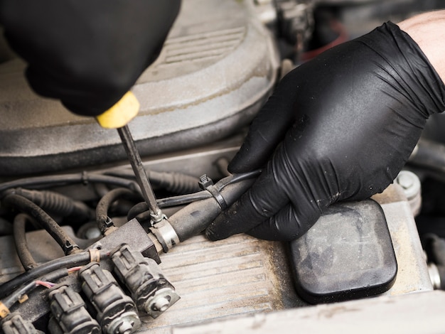 Man using screwdriver to tighten a cable