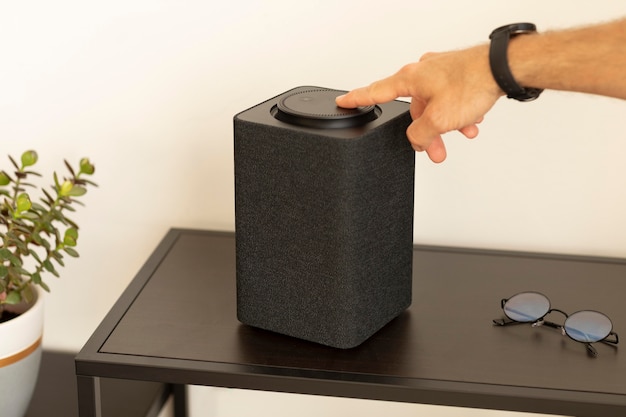 Free Photo man using a smart speaker