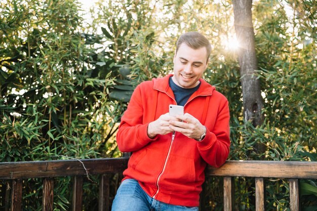 Man using smartphone in park