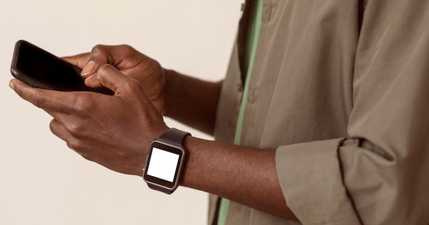 Man using smartphone and wearing smart watch