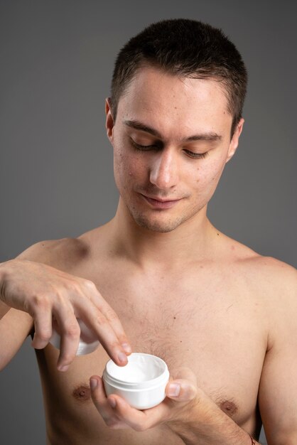 Man using a special cream for acne