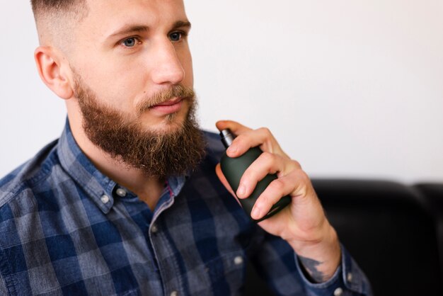 Man using a spray after having a haircut