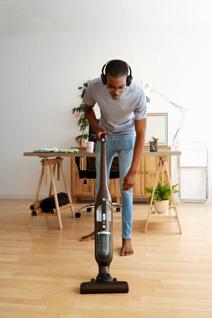 Man vacuuming floor front view