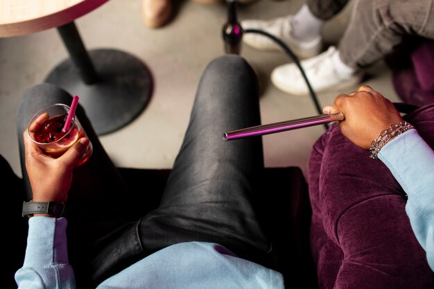 Man vaping from a hookah indoors