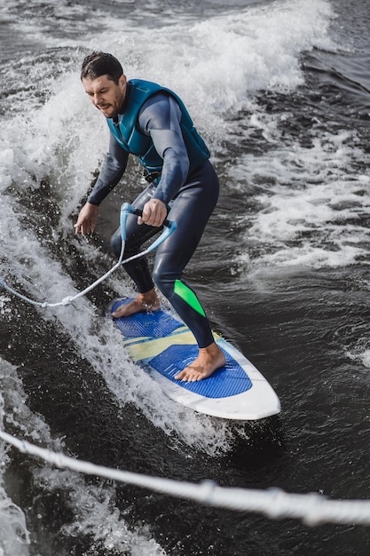 Free photo man on wakesurfing. wave from the boat.