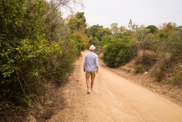 Man walking on the road with relax mood.