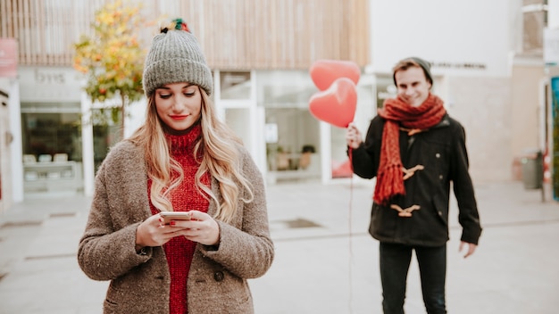 Free Photo man walking to woman with balloons