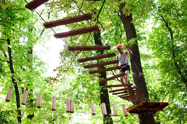 Free photo man walks on the rope path in the air