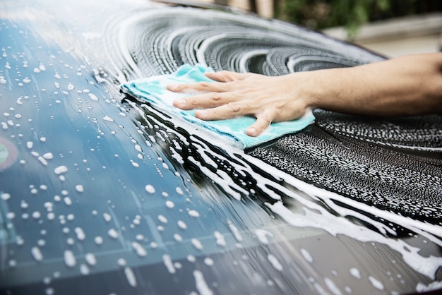 Man wash car using shampoo 