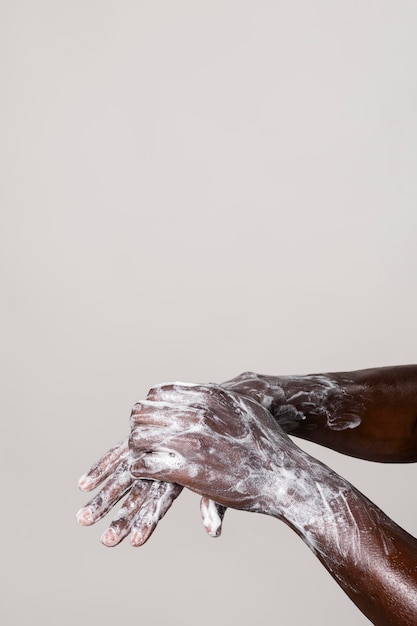 Free photo man washing hands with soap