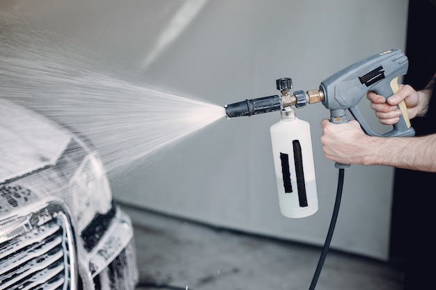 Man washing his car in a garage