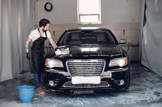 Man washing his car in a garage