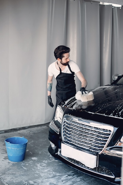 Man washing his car in a garage