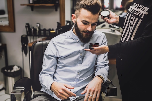 Man watching cosmetics in barbershop