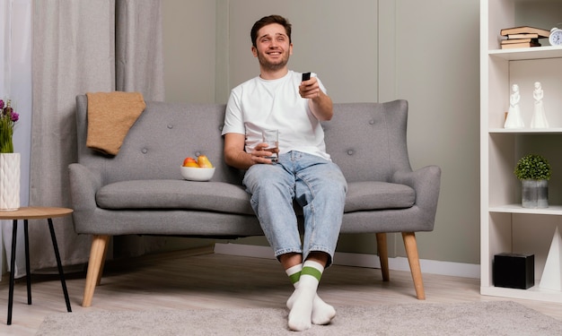 Man watching tv and eating popcorn