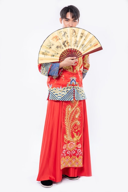 Free Photo man wear cheongsam suit show the chinese hand fan on big event in chinese new year