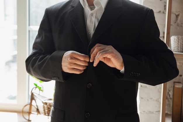 Free Photo man wearing black jacket. close up of caucasian male hands. concept of business, finance, job, online shopping or sales.