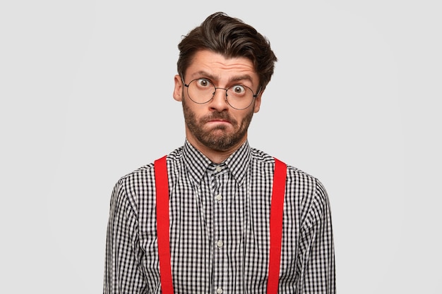 Man wearing checkered shirt and red suspenders