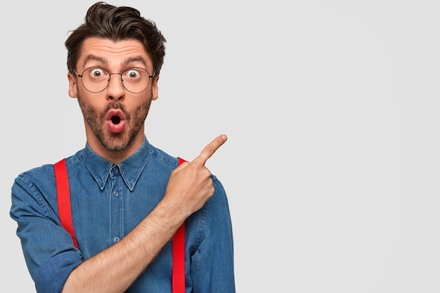 Man wearing denim shirt and red suspenders