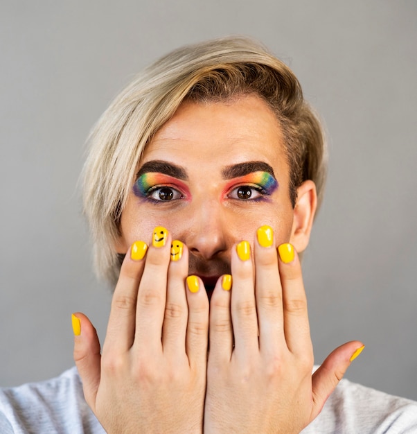 Man wearing make-up cosmetics and nail polish close-up