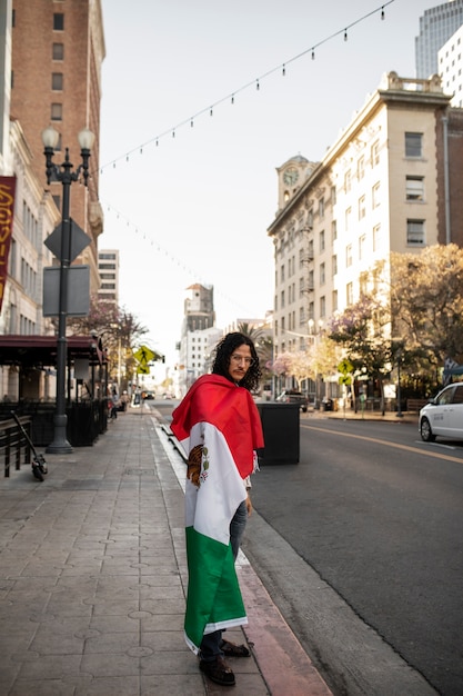 Free Photo man wearing mexican flag full shot