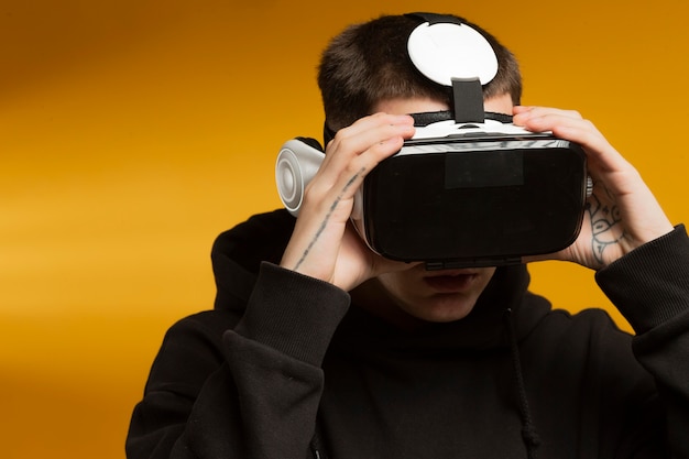 Free photo man wearing modern virtual reality goggles