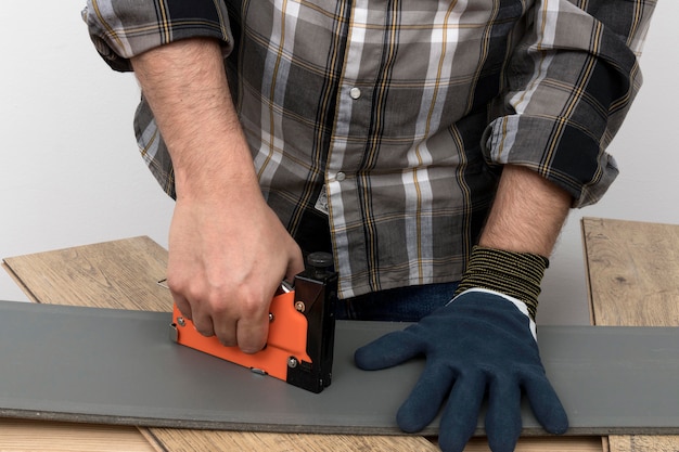 Free photo man wearing protection gloves carpentry workshop concept