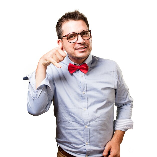 Man wearing a red bow tie. Doing a phone gesture.