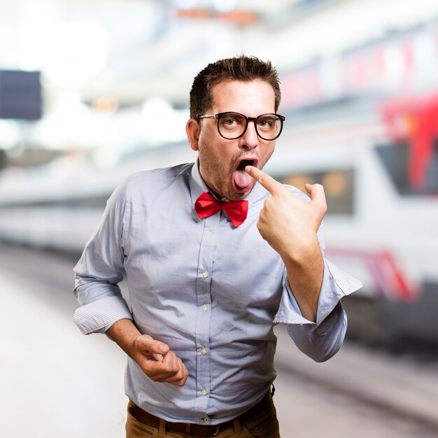 Man wearing a red bow tie. Looking sick.